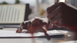 Man holding pen in hand and writing something 