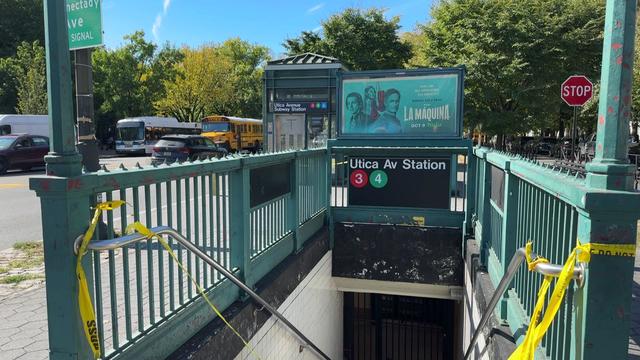 Torn crime scene tape at the entrance of the Utica Avenue subway station. 