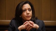 Kamala Harris in 2010, when she was running for California Attorney General, leans forward with her chin on her clasped hands