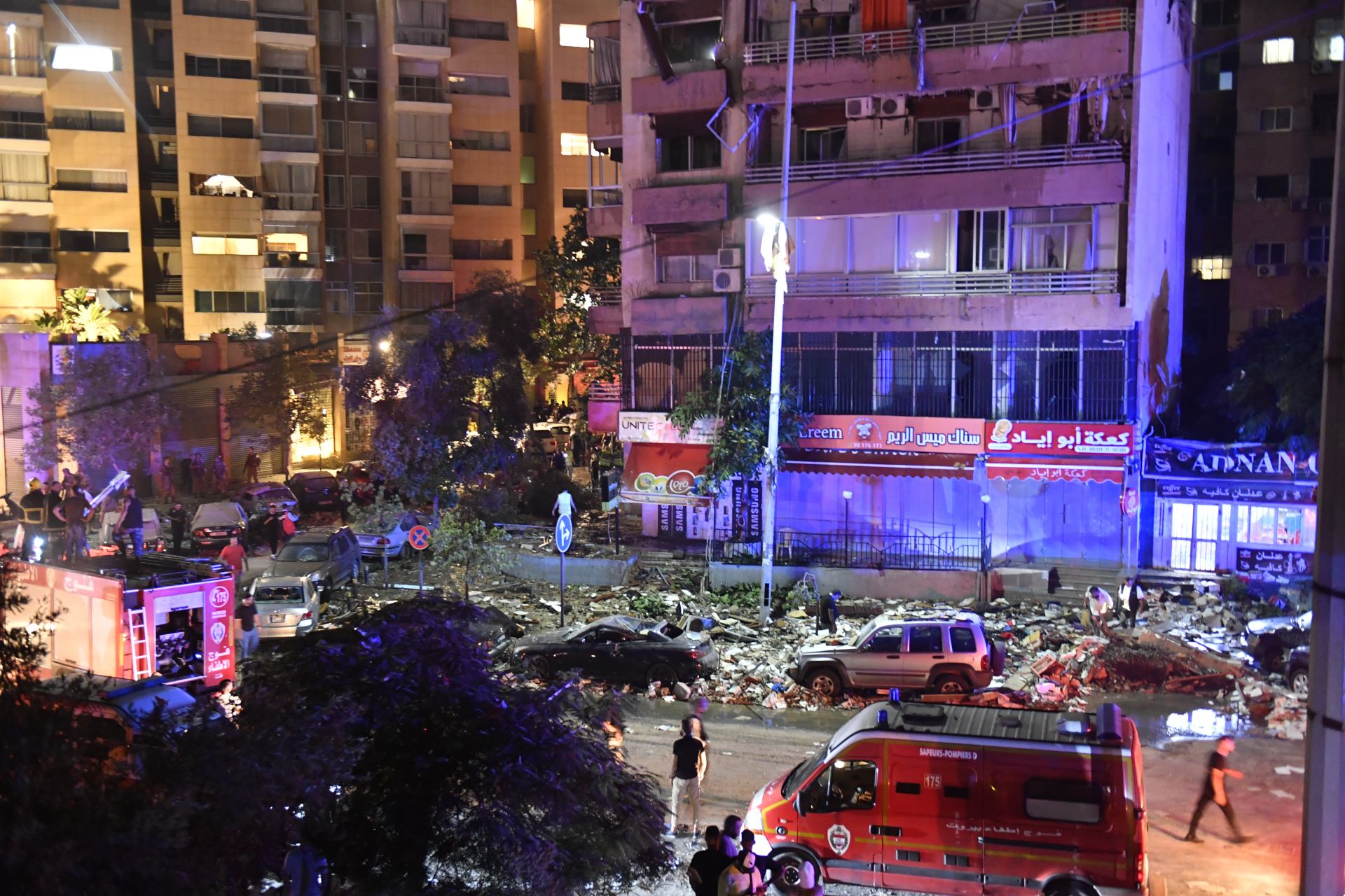 View of building damage in a city street at night