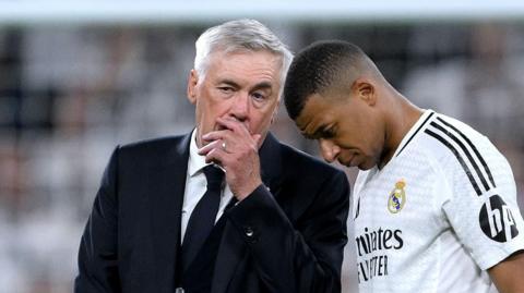 Real Madrid boss Carlo Ancelotti talks to Kylian Mbappe after a home match