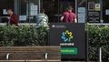 People wait outside a Services Australia outlet