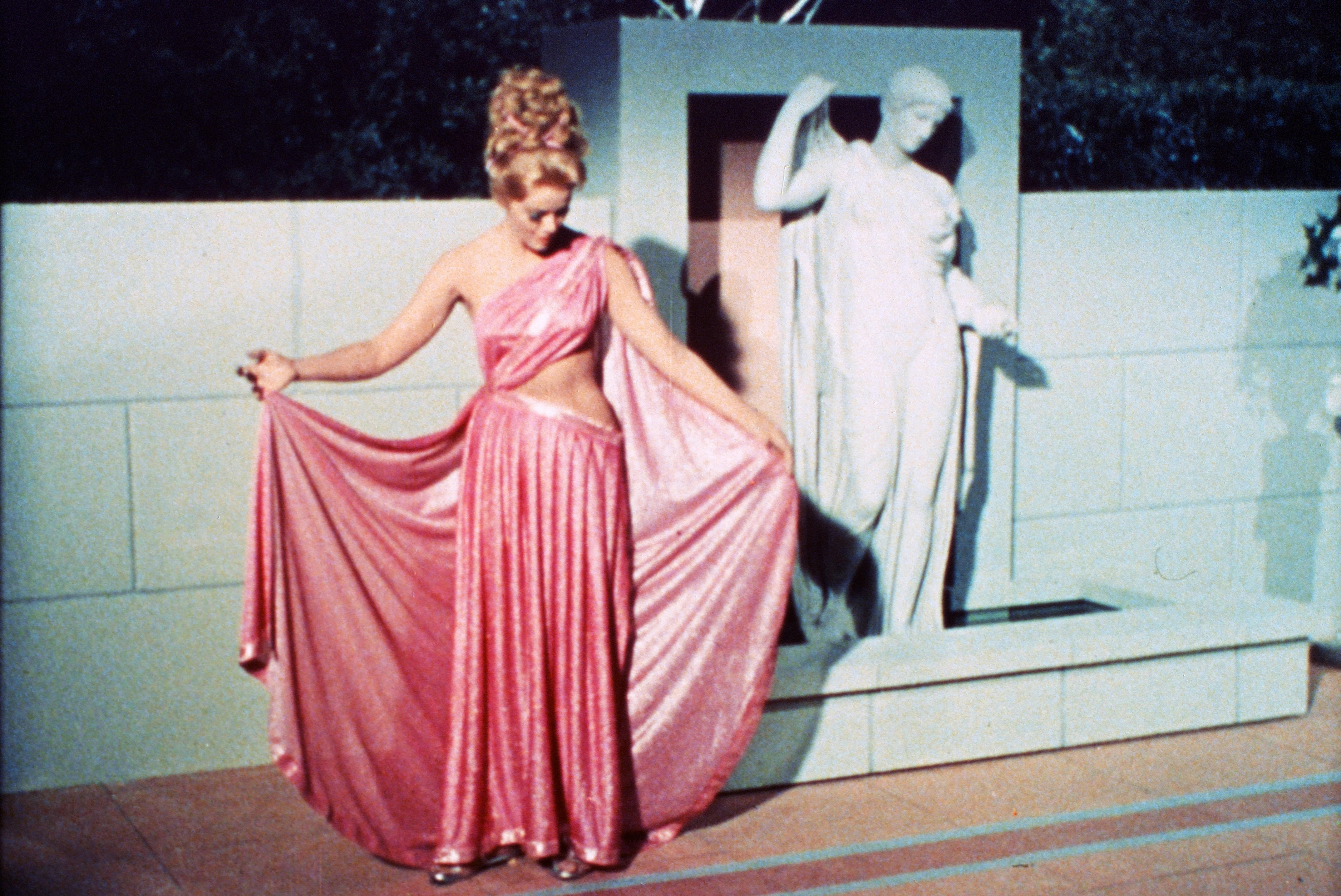 Lt. Carolyn Palamas (Leslie Parrish) fans a layer of her pink gown on the surface of a planet in 'Who Mourns for Adonais?'