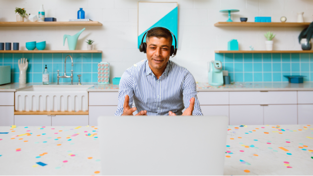 Man at computer with confetti