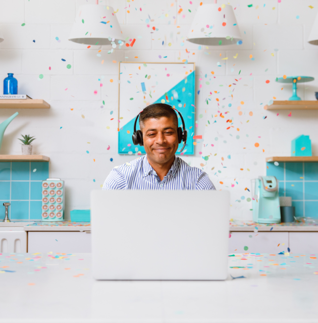 Man at computer with confetti