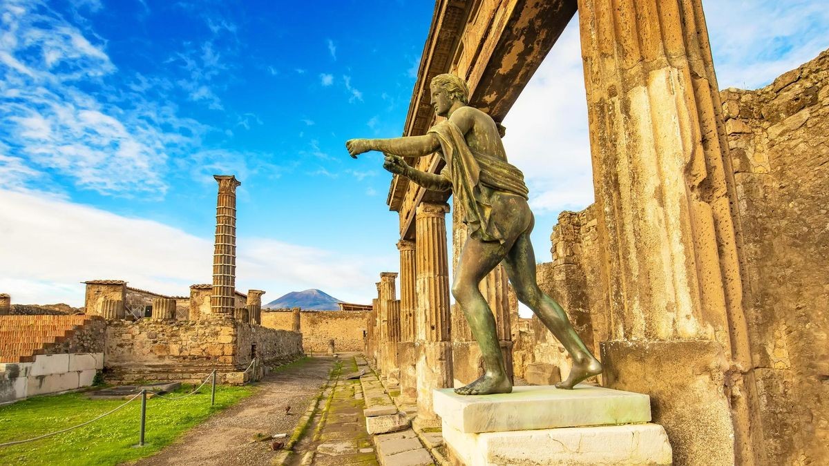 Ancient Pompeii city skyline and Apollo statue, Italy