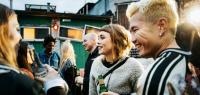 Young Clubgoers Drinking And Catching Up At Open Air Nightclub