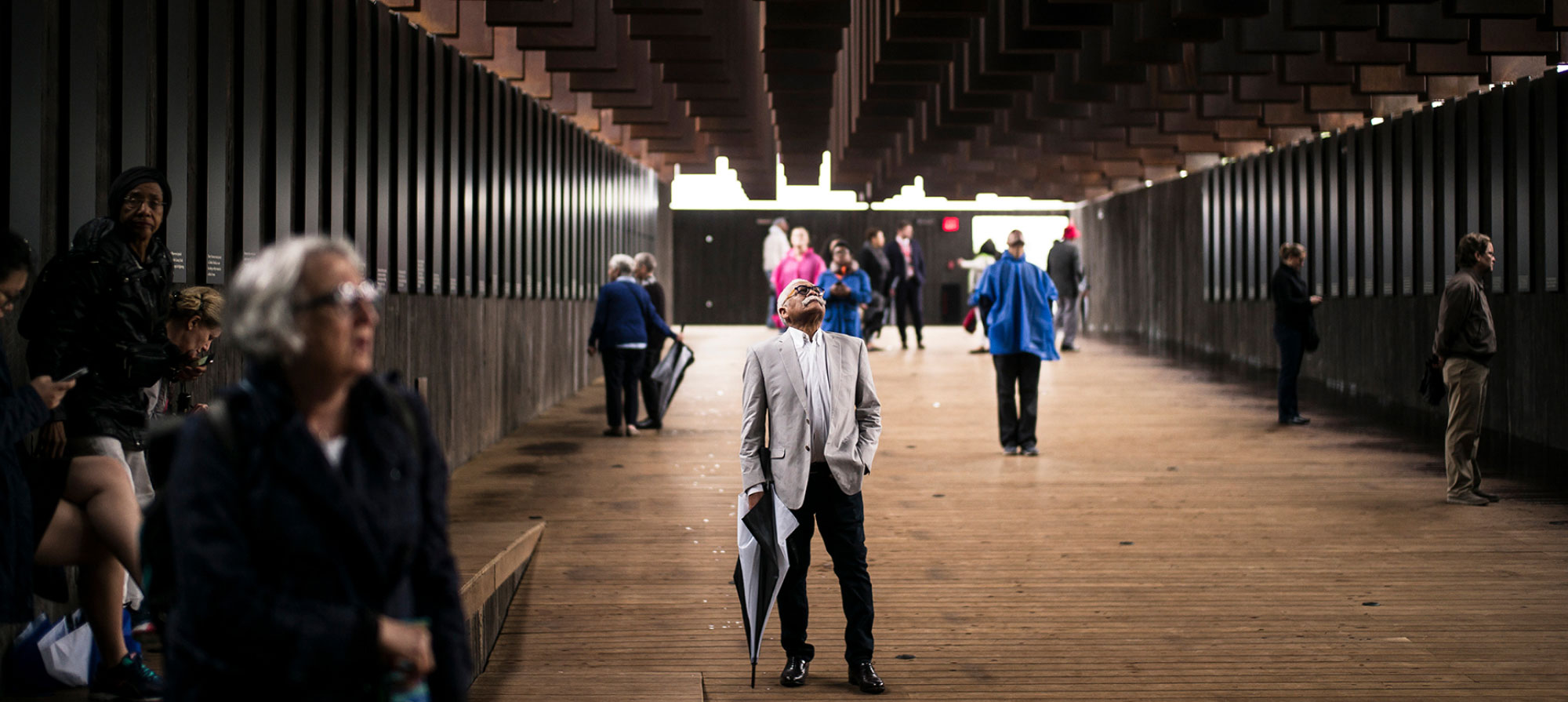 A man looks up at the monuments suspended overhead at the National Memorial for Peace and Justice.