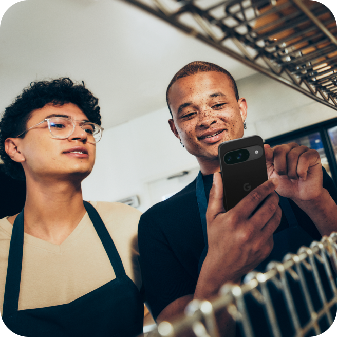 Two employees using a Pixel 9 in a bakery.