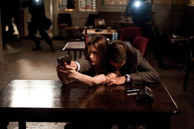 Anne Hathaway and Burn Gorman in The Dark Knight Rises (2012)