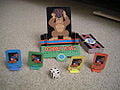 A Donkey Kong pawn, four different-colored player pawns, a die, and a deck