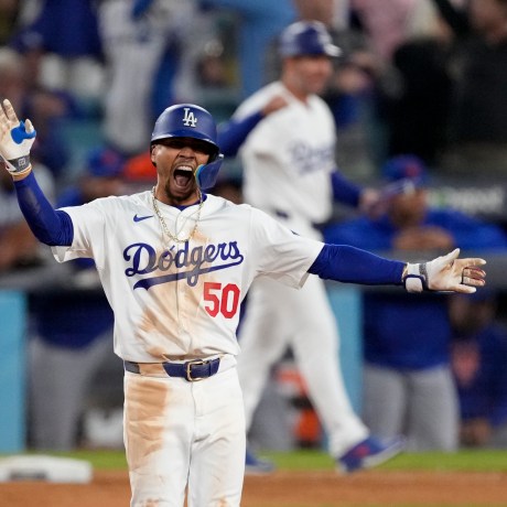 Los Angeles Dodgers' Mookie Betts celebrates a RBI-double against the New York Mets during the eighth inning in Game 6 of a baseball NL Championship Series, Sunday, Oct. 20, 2024, in Los Angeles. (AP Photo/Mark J. Terrill)