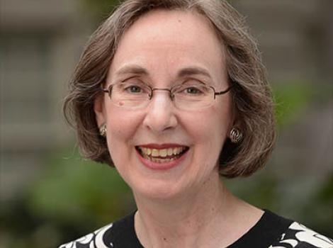 Smiling woman with brown hair and glasses