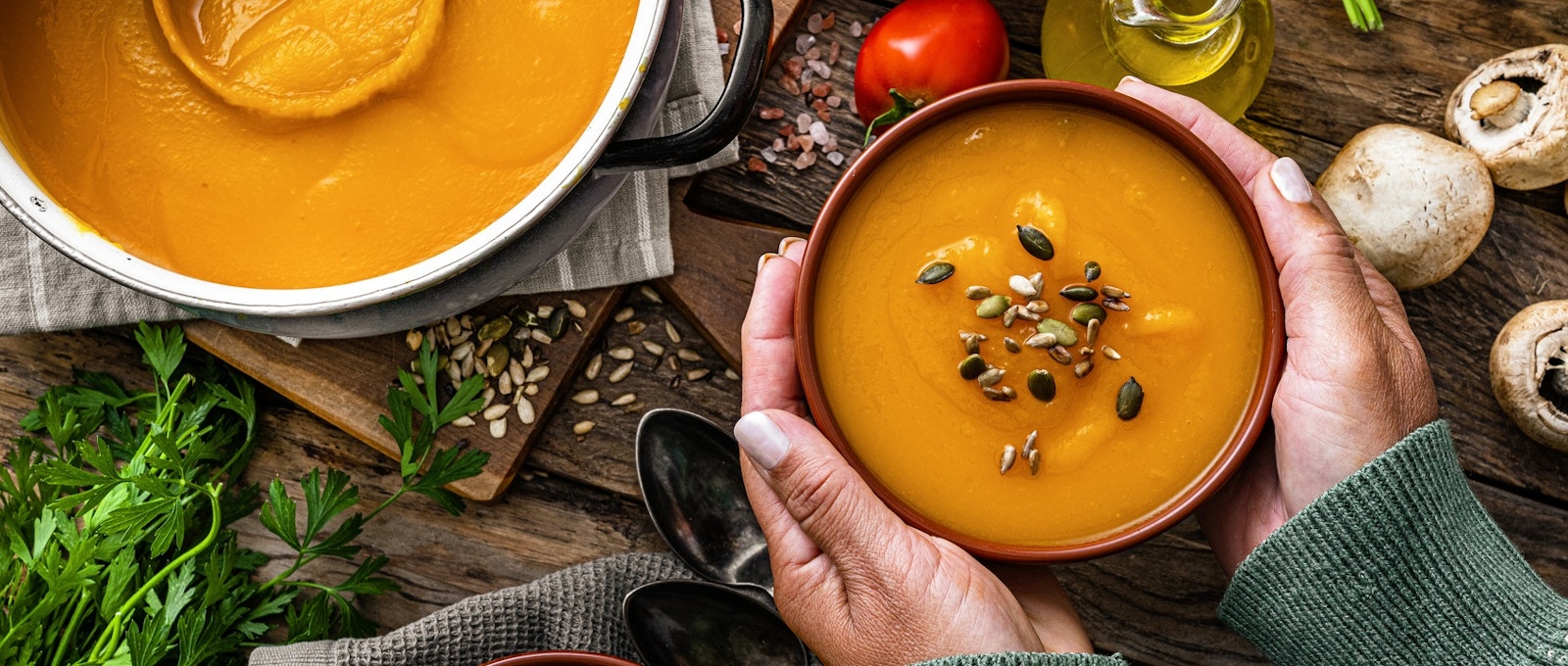 Woman holding a bowl of pumpkin soup