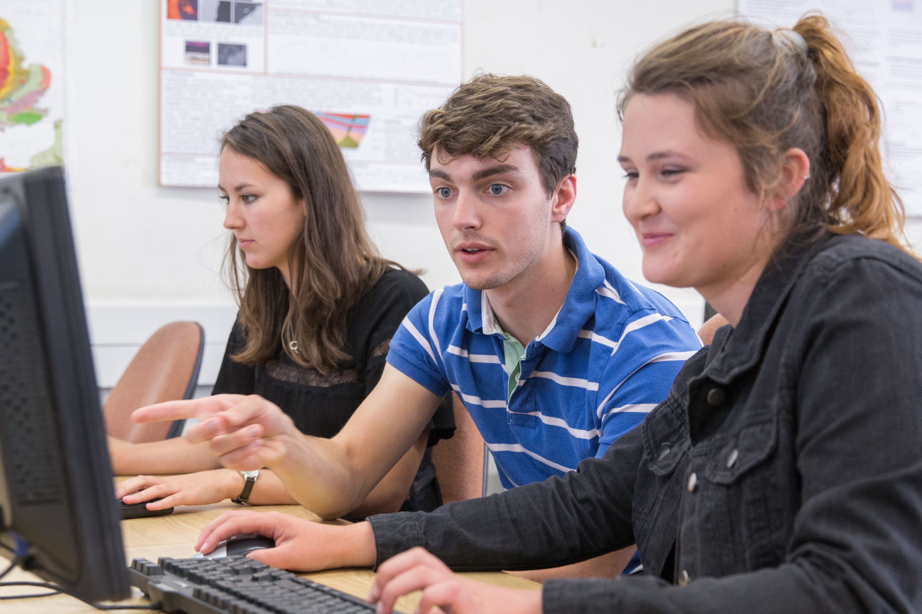 Three students working on computers