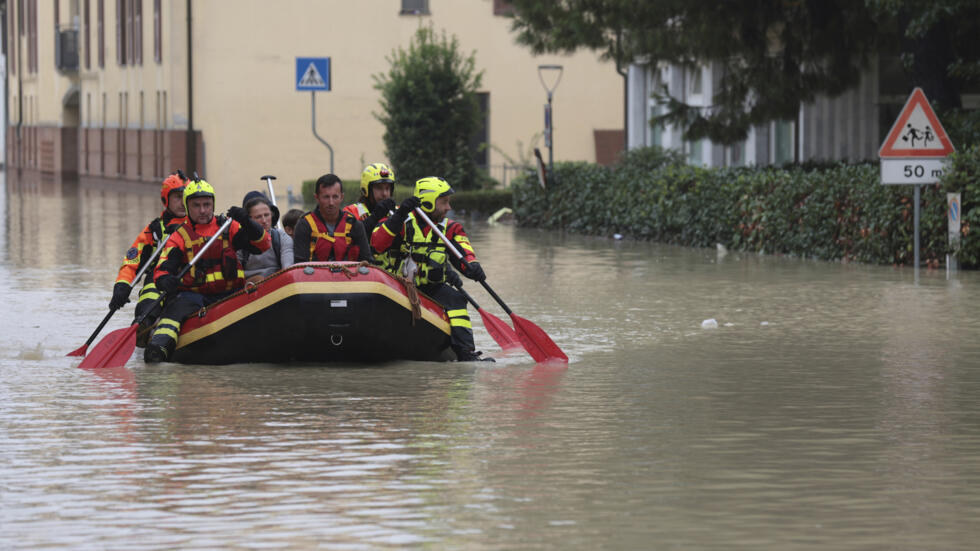 Firefighters use a dingy boat to evacuate civilians after flooding in Faenza, in the region of Emilia Romagna, Italy, Thursday, Sept. 19, 2024.