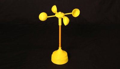 Image of a yellow 3D printed anemometer with a base, a pencil as a vertical component and four half spheres on a horizonal top piece