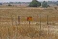 Mine field with a warning sign