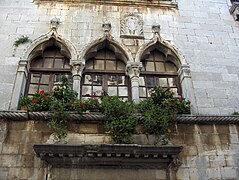 A triform of Venetian ogee arches with trefoils