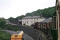 The train rounds the corner at the end of the Cob, to begin the ascent to Blaenau Ffestiniog.