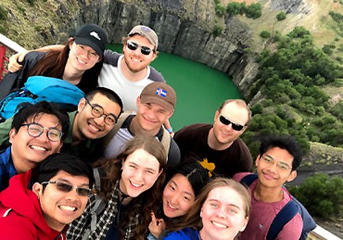 A group of students stand in front of the giant water filled Big Hole in Kimberley.