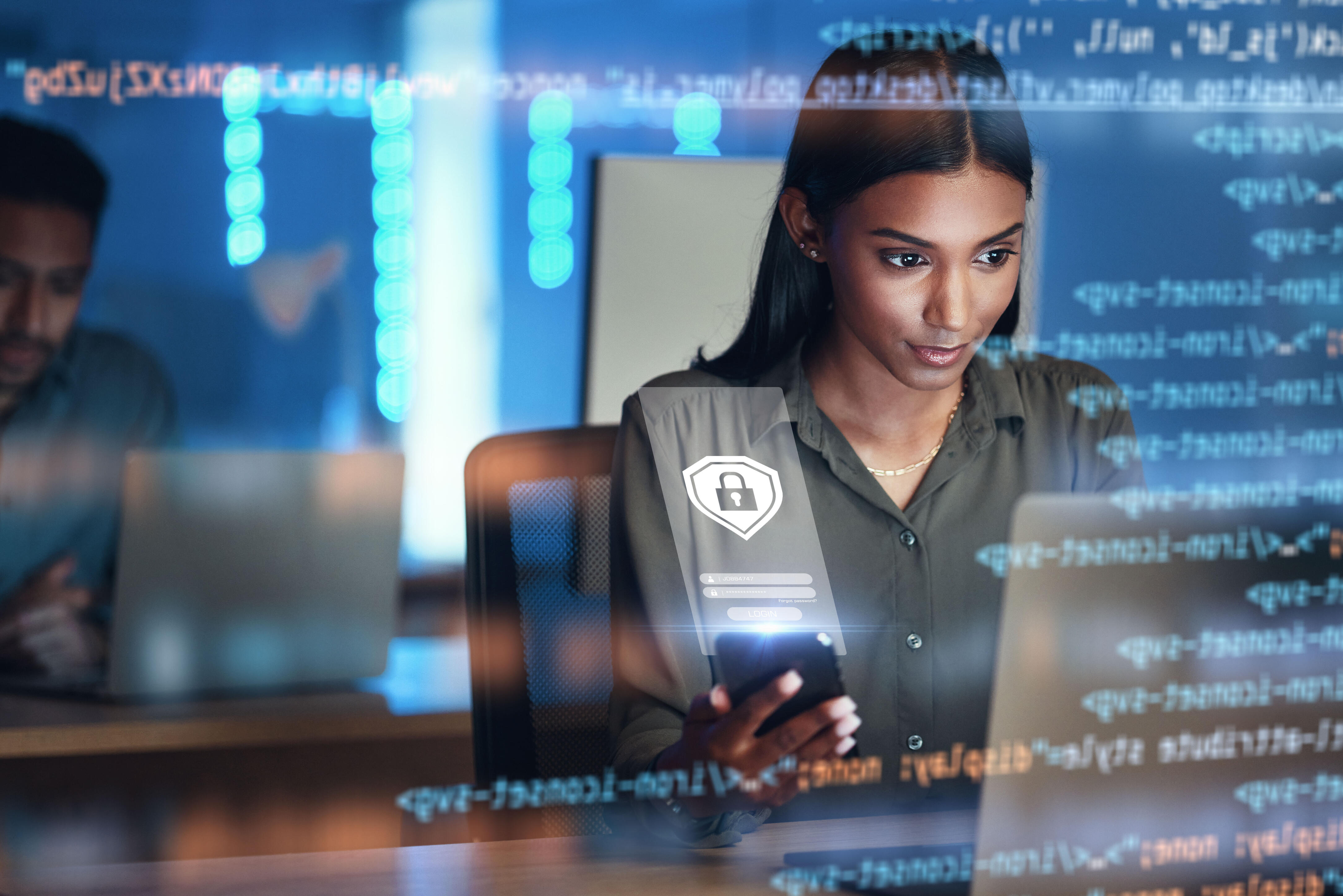 woman using phone and laptop with code visualization