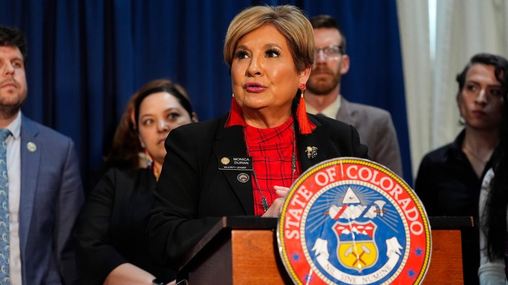 Monica Duran stands behind a podium with a crest that reads, "State of Colorado."