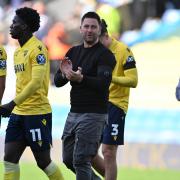 Oxford United head coach Des Buckingham applauds the home support at full-time against West Brom