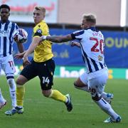 Louie Sibley battles for the ball against West Brom