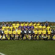 Oxford United players with pupils from Pegasus Primary School for the football club’s squad photo