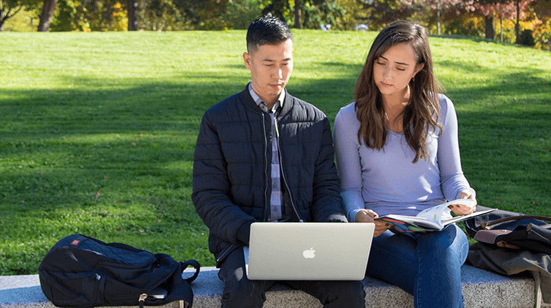 Students Looking at Computer on Campus